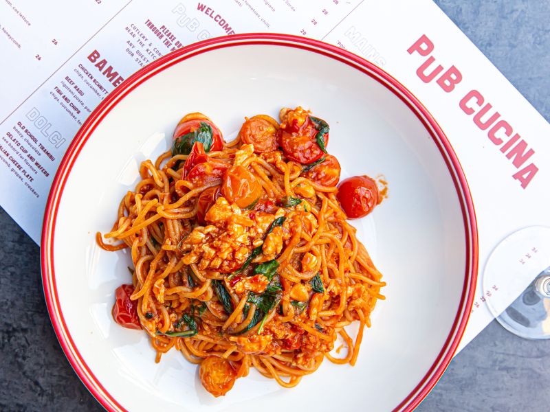 A plate of pasta on top of a menu