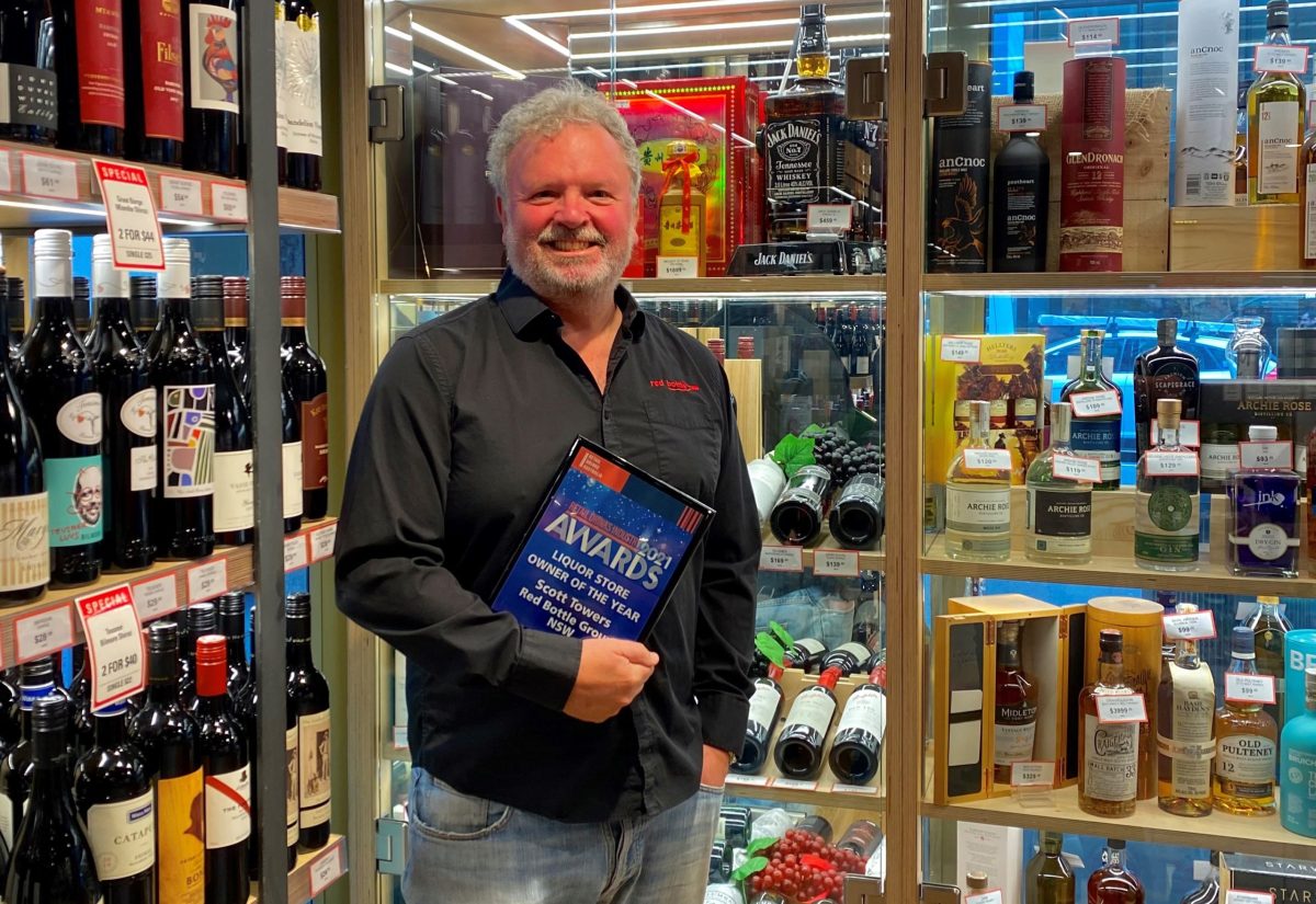 Scott Towers from Red Bottle Group NSW holding his Retail Drinks Industry Award for Liquor Store Owner of the Year. Red Bottle Group plays to its strengths