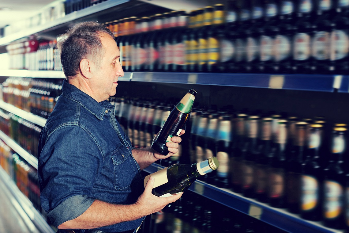 Man choosing beer at the grocery store NPD