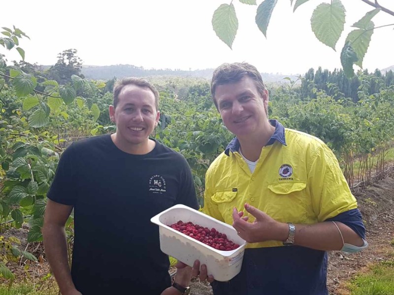 Jesse Cartwright of Asahi and Richard Clark of Westerway Raspberry Farm holding a punnet of raspberries