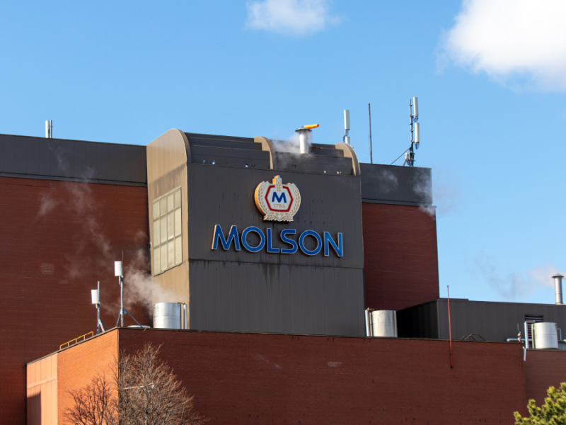 Image of the red bricked molson brewery against a blue sky with clouds