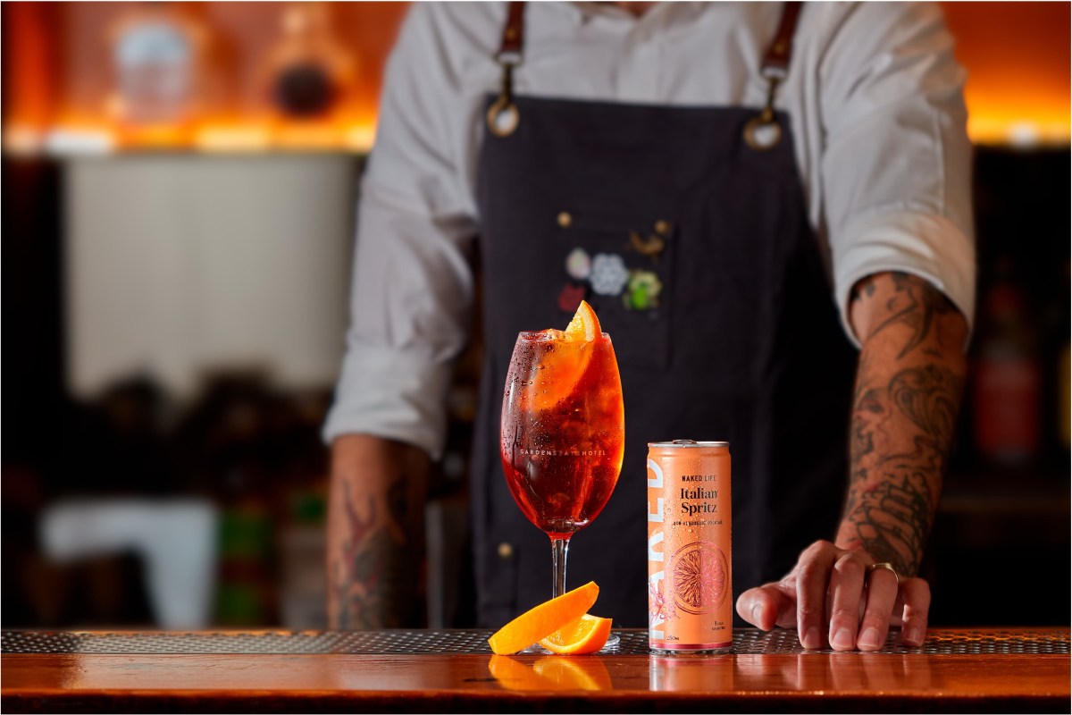 Bartender serves pre-mixed cocktail drink on-premise