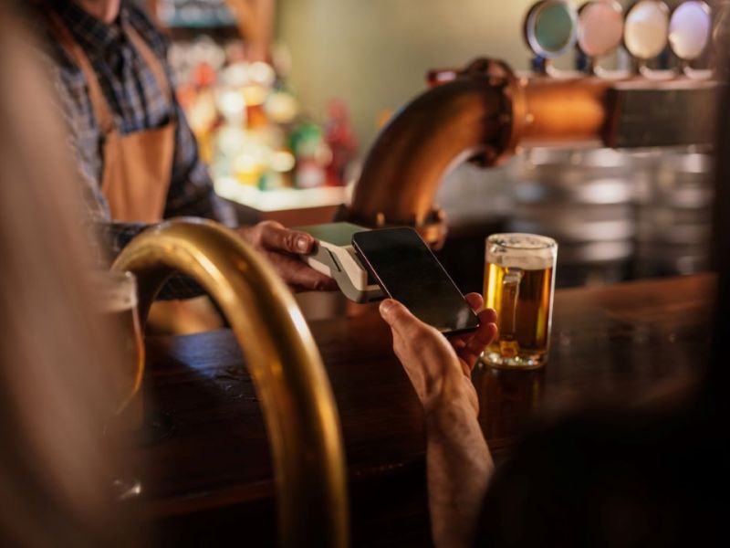 person tipping across a bar